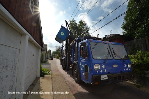 St. Louis refuse truck picking up the blue recycling dumpsters.